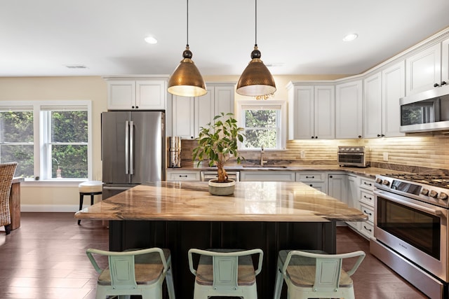 735 Maple Ave, West Cape May, NJ 08204 - kitchen with appliances with stainless steel finishes, light stone counters, backsplash, white cabinetry, and recessed lighting