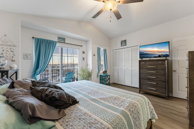 bedroom featuring vaulted ceiling, a closet, light hardwood / wood-style flooring, access to outside, and ceiling fan