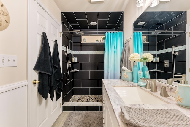 bathroom with wood-type flooring, vanity, and a shower with shower curtain