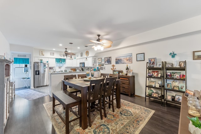 dining room with ceiling fan and dark wood-type flooring