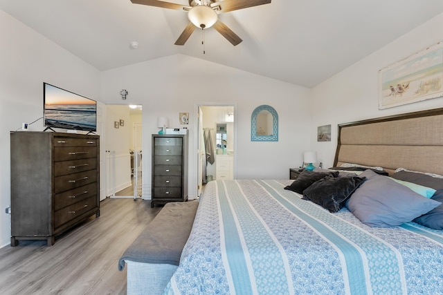 bedroom featuring ceiling fan, connected bathroom, hardwood / wood-style flooring, and lofted ceiling