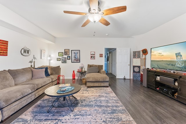 living room with ceiling fan and dark wood-type flooring