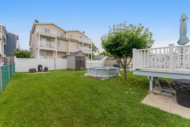 214 W 12th Ave, North Wildwood, NJ 08260 - fenced backyard featuring a storage unit, an outdoor fire pit, and a deck
