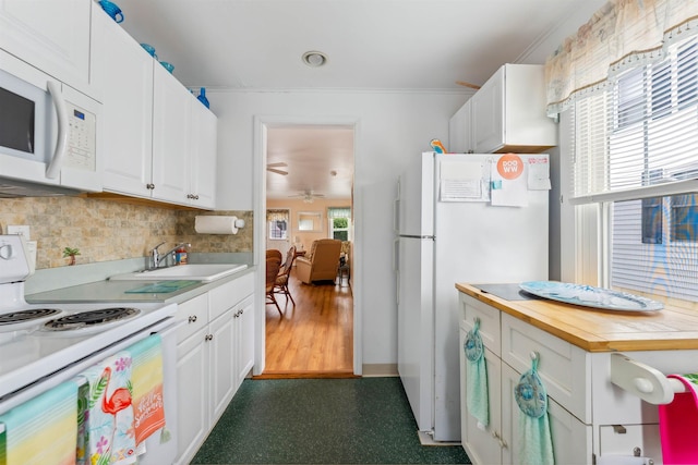 214 W 12th Ave, North Wildwood, NJ 08260 - kitchen with white appliances, white cabinetry, decorative backsplash, dark floors, and ornamental molding