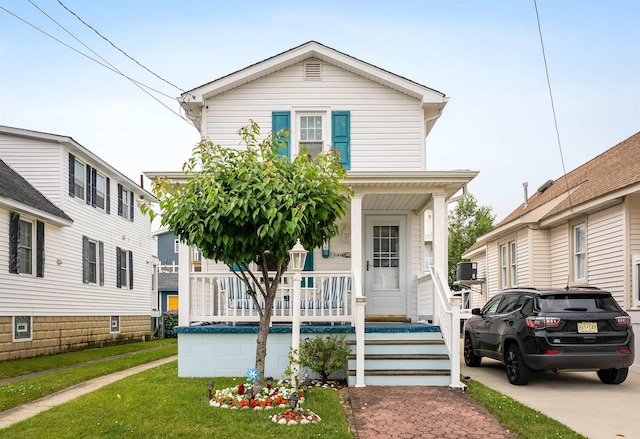 214 W 12th Ave, North Wildwood, NJ 08260 - view of front of home with covered porch and a front lawn
