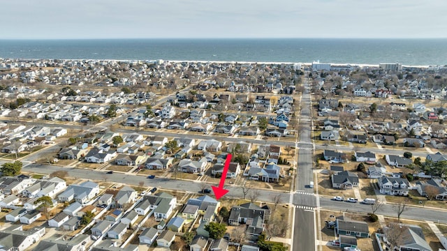 drone / aerial view featuring a water view and a residential view