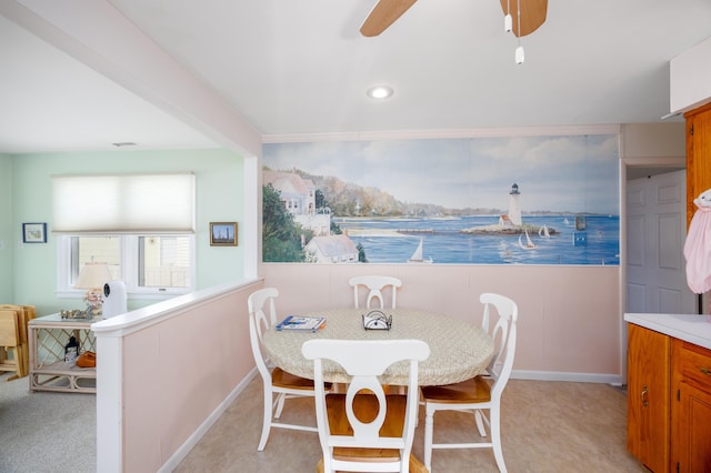 dining room featuring visible vents, a ceiling fan, and light colored carpet