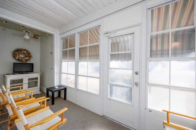 entryway featuring a ceiling fan and carpet flooring