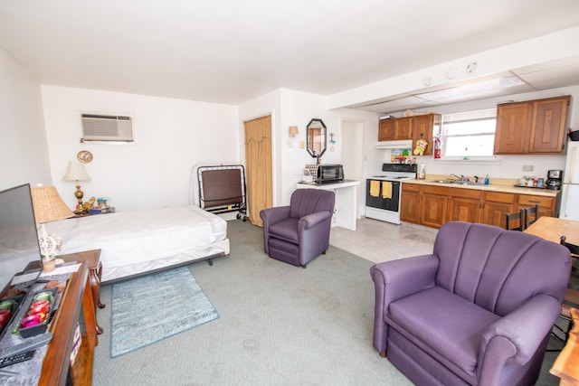 bedroom featuring white fridge, a wall mounted air conditioner, light carpet, and sink