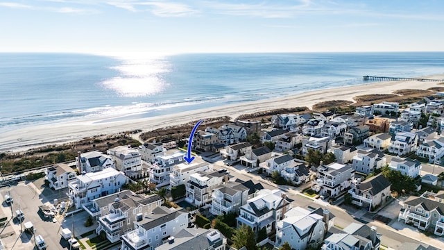 bird's eye view featuring a view of the beach and a water view