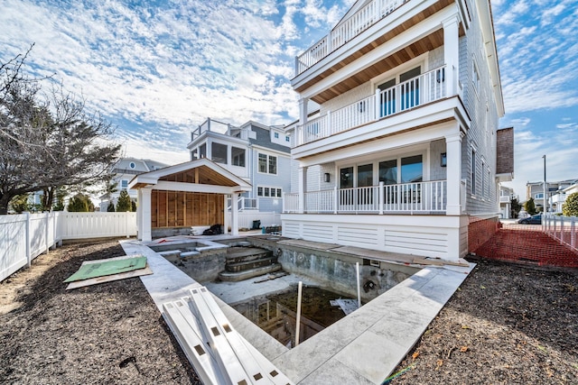 back of house featuring a balcony