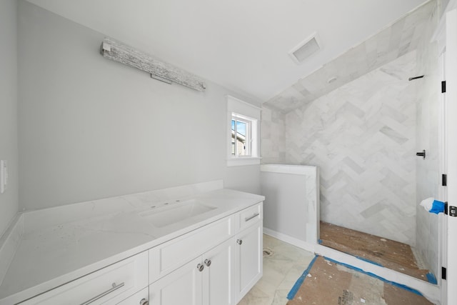 bathroom featuring vanity and a shower