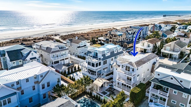 birds eye view of property with a view of the beach and a water view