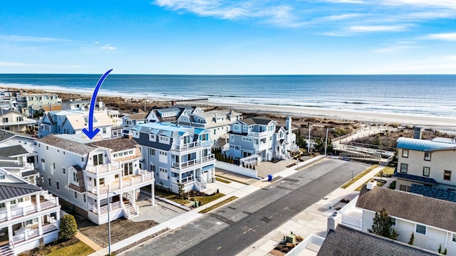 aerial view featuring a water view and a beach view