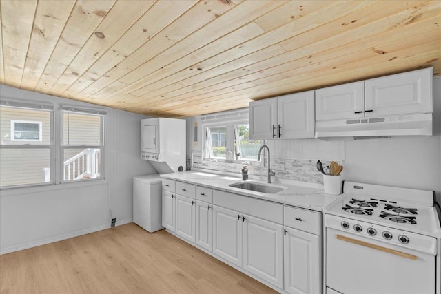 6 E Atlantic Ave, Villas, NJ 08251 - kitchen with white gas range, under cabinet range hood, wood ceiling, a sink, and stacked washer / drying machine