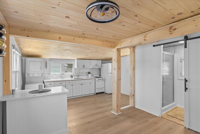 6 E Atlantic Ave, Villas, NJ 08251 - kitchen featuring stacked washer / drying machine, wooden ceiling, white appliances, light countertops, and light wood-style flooring