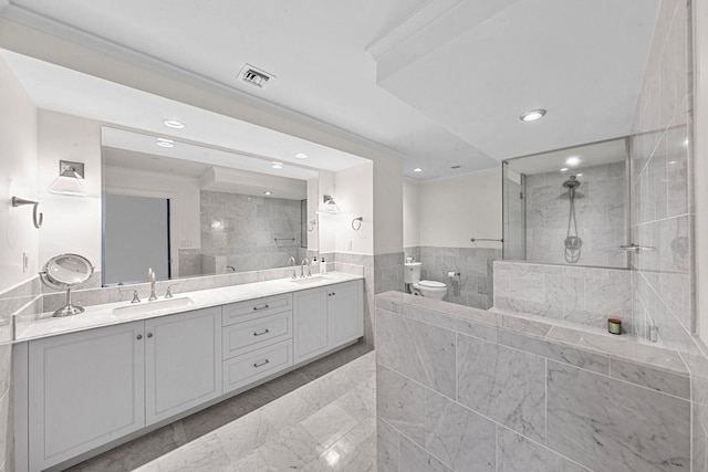 bathroom featuring crown molding, toilet, vanity, and tiled shower