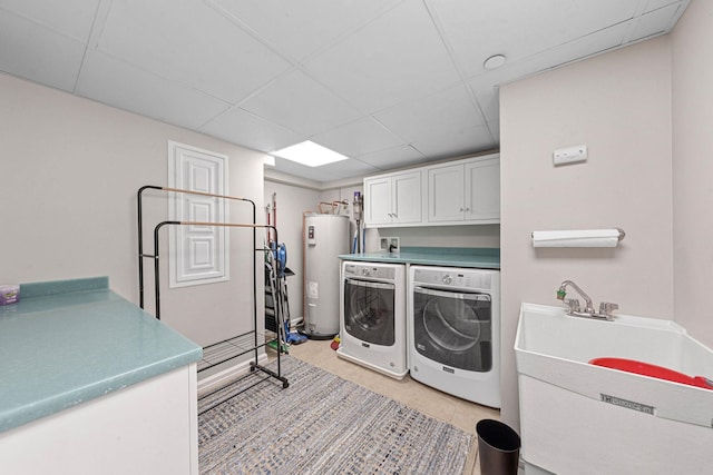 laundry area with sink, cabinets, water heater, independent washer and dryer, and light tile patterned flooring