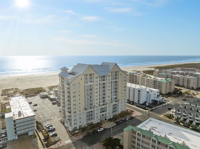 birds eye view of property featuring a water view and a beach view