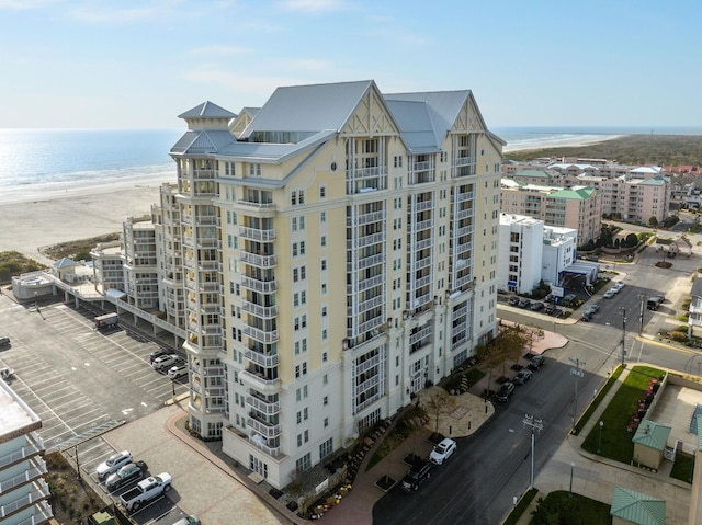 view of property featuring a view of the beach and a water view