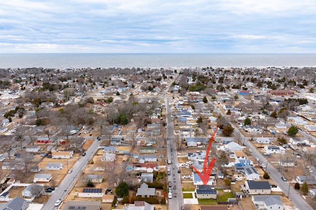 drone / aerial view featuring a water view and a residential view