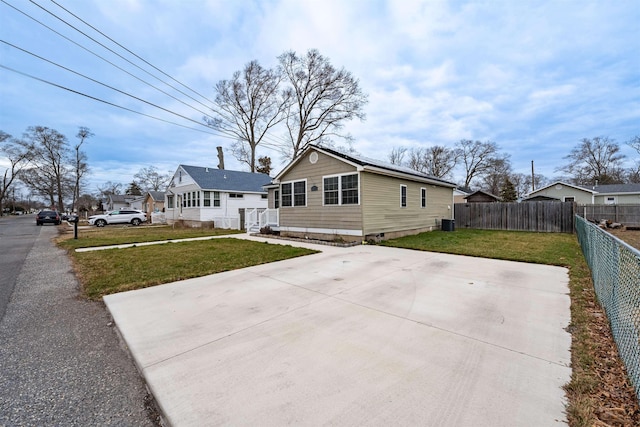 exterior space with fence and a front yard