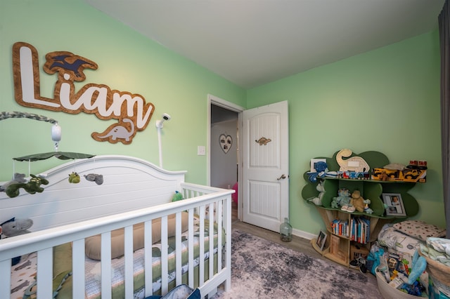 bedroom featuring baseboards and wood finished floors