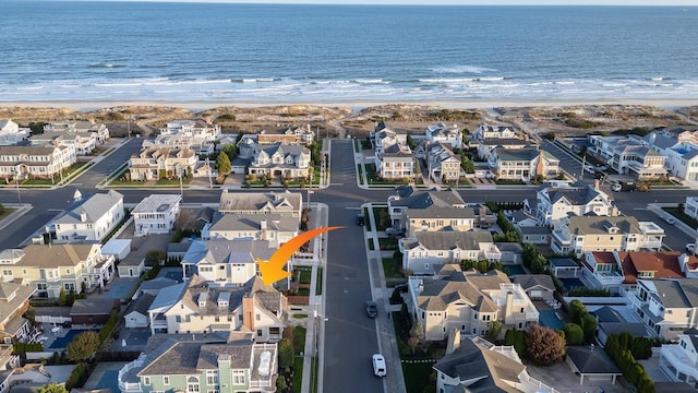 drone / aerial view with a water view and a view of the beach