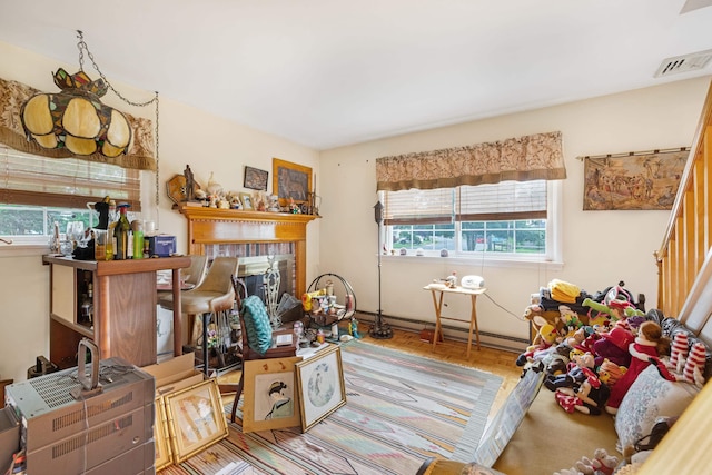 100 Oakdale Ave, Villas, NJ 08251 - living room with a baseboard radiator, wood finished floors, a fireplace, and stairway