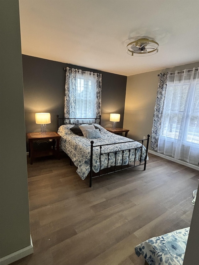 bedroom featuring baseboards and wood finished floors