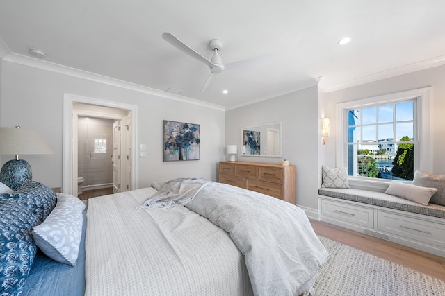 bedroom featuring light hardwood / wood-style floors, ceiling fan, ornamental molding, and ensuite bathroom