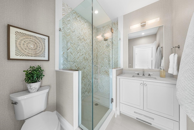 bathroom featuring vanity, an enclosed shower, and toilet