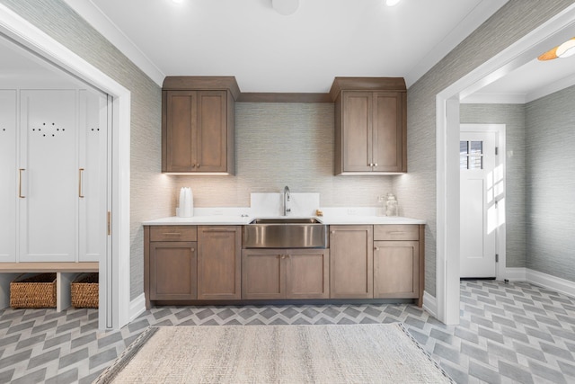 kitchen featuring crown molding and sink