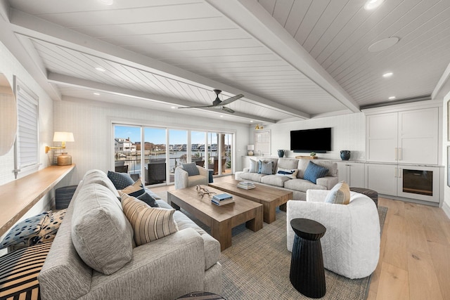 living room featuring beam ceiling, light wood-type flooring, ceiling fan, and wood ceiling