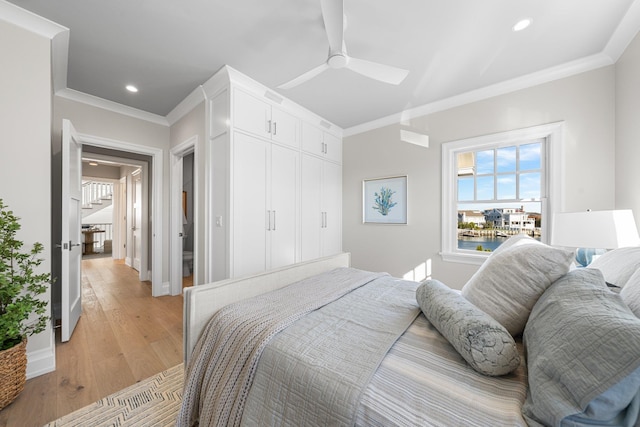 bedroom with ceiling fan, light hardwood / wood-style flooring, and crown molding