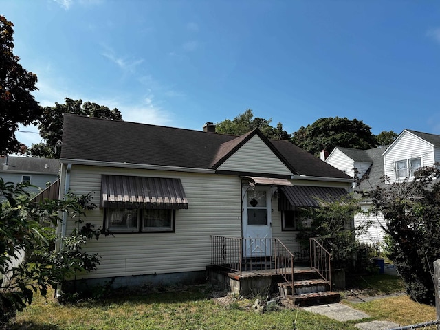 bungalow-style house with a front yard