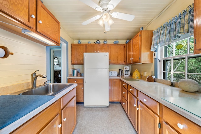 2320 Shore Rd, Ocean View, NJ 08210 - kitchen with freestanding refrigerator, a sink, light countertops, and brown cabinetry