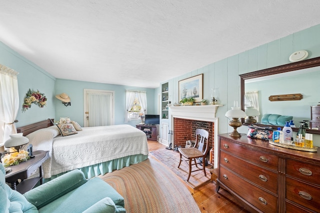 2320 Shore Rd, Ocean View, NJ 08210 - bedroom with wood finished floors, a fireplace, and a textured ceiling