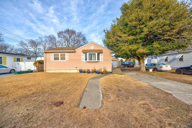 view of front of property with a garage and a front yard