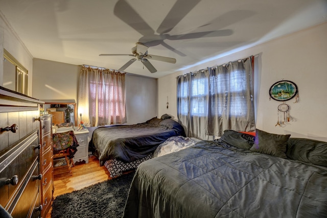 bedroom featuring hardwood / wood-style flooring and ceiling fan