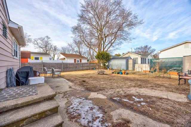 view of yard with a storage unit and a patio area