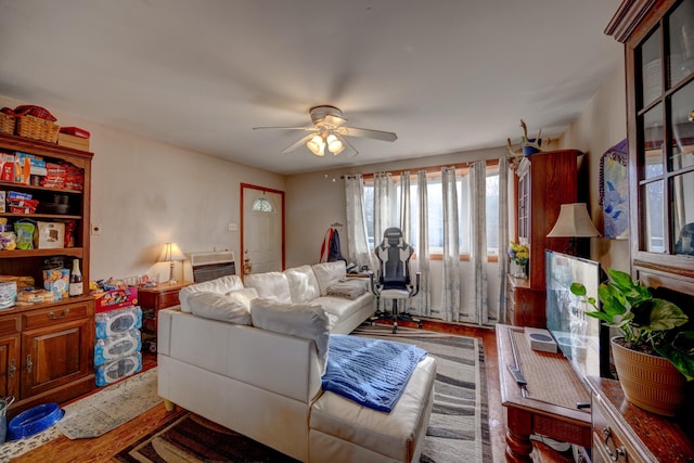 living room with wood-type flooring and ceiling fan