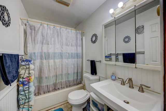 full bathroom with sink, shower / bathtub combination with curtain, and toilet