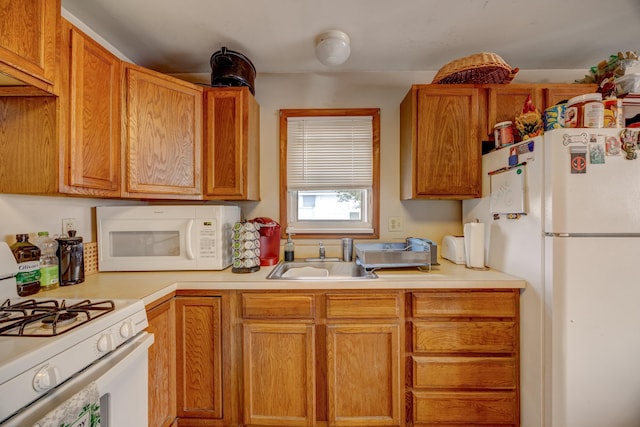 kitchen featuring white appliances and sink