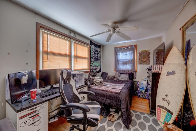 bedroom with light hardwood / wood-style flooring and ceiling fan