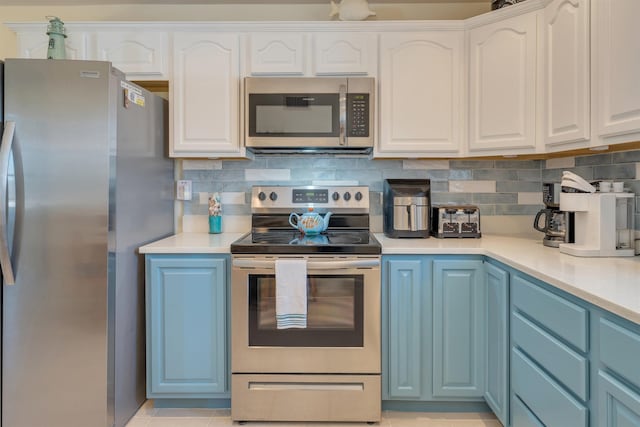 kitchen featuring tasteful backsplash, appliances with stainless steel finishes, white cabinets, and light countertops