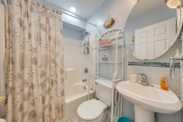 full bath with tasteful backsplash, shower / bath combo, a sink, and toilet