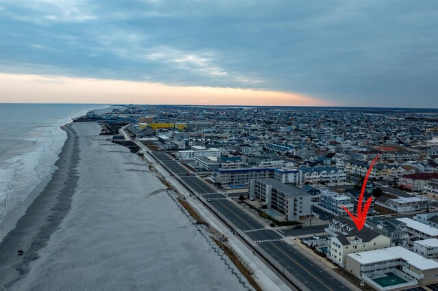 birds eye view of property with a water view, a view of city, and a view of the beach