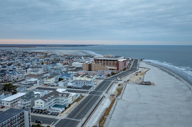 aerial view featuring a view of the beach, a water view, and a city view