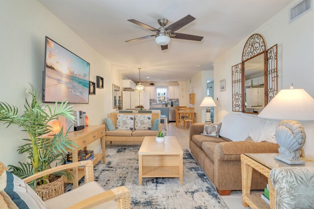 living room featuring visible vents and a ceiling fan